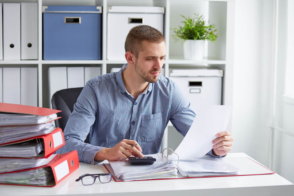 man reviewing document at desk